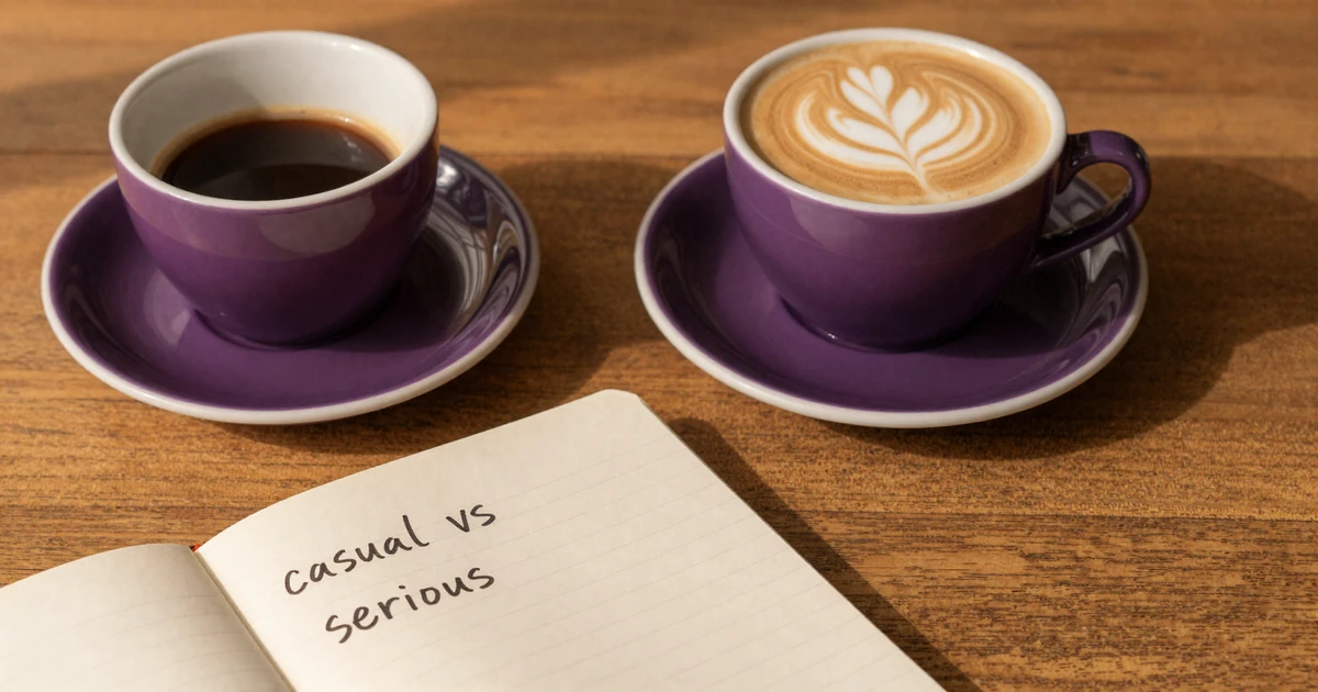 Two coffee cups beside an open notebook weighing casual dating versus serious relationships